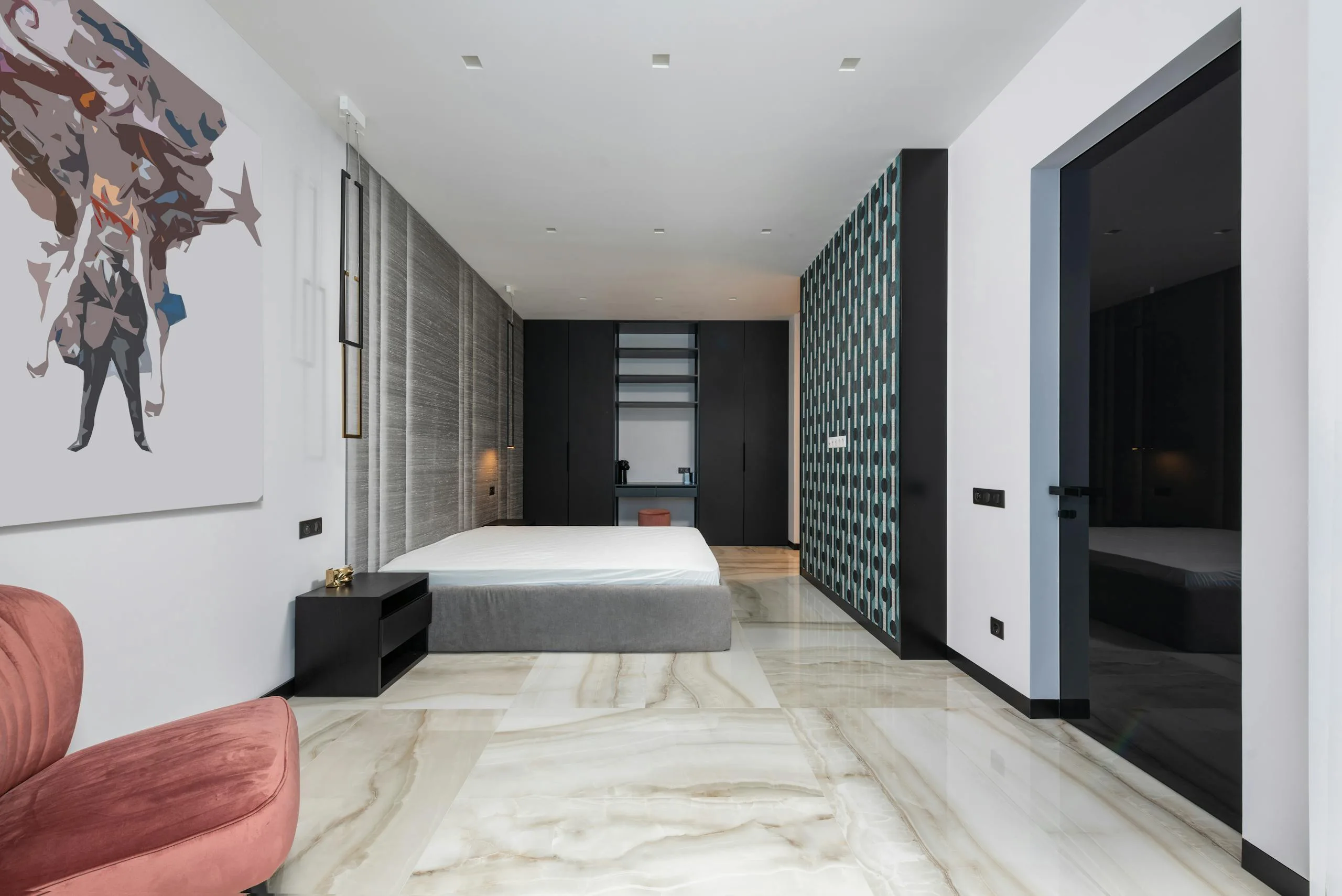 Interior of minimalist styled bedroom with comfortable armchair and bed decorated with creative painting